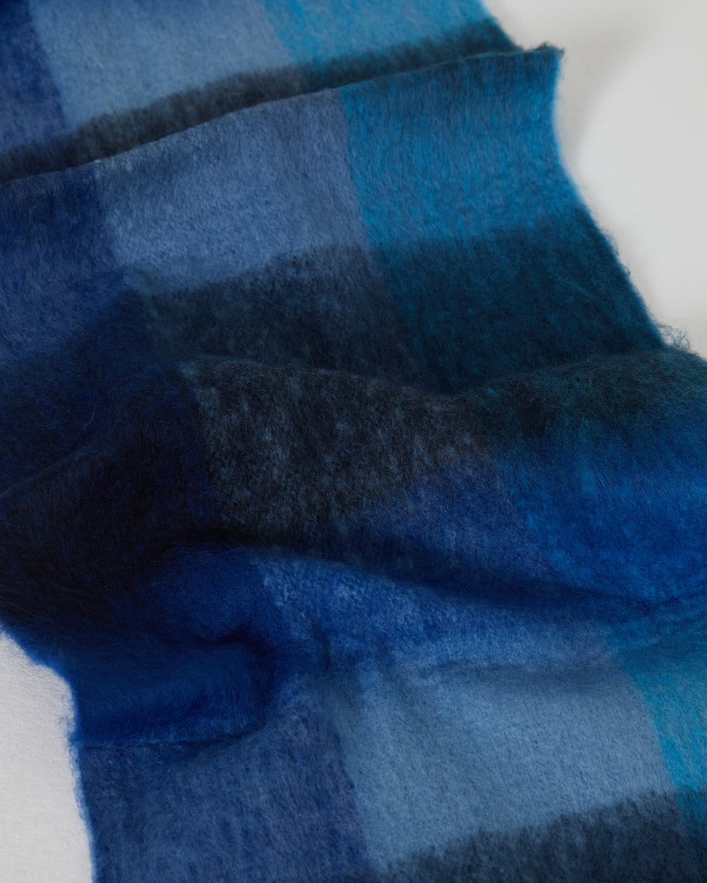 Women's checked scarf in blue tones with long fringes