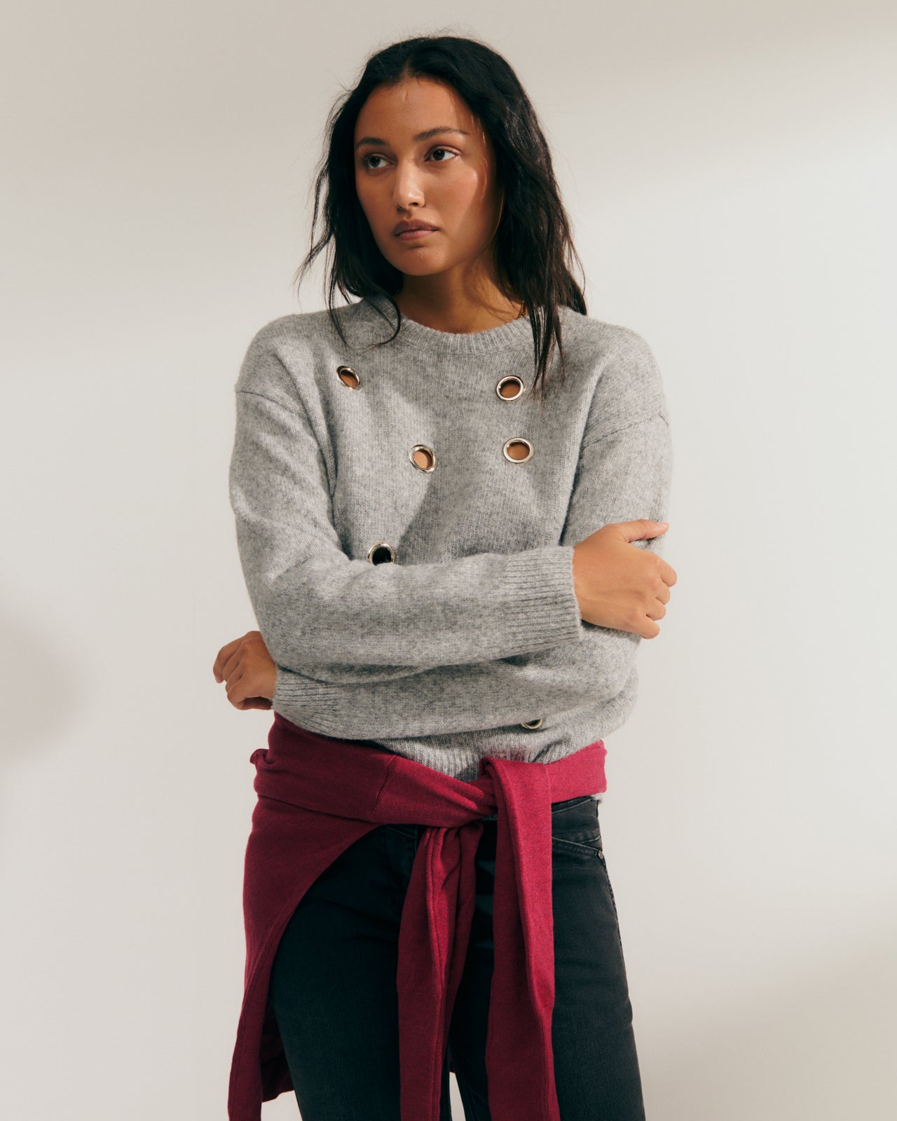 Women's fancy sweater with metal eyelets