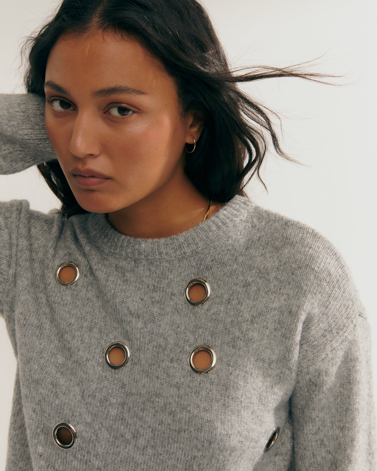 Women's fancy sweater with metal eyelets